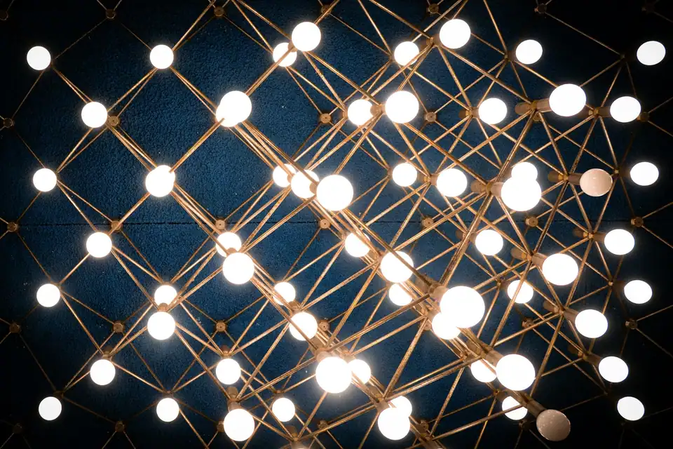 A ceiling of small round lamps strung on a grid of fine wires