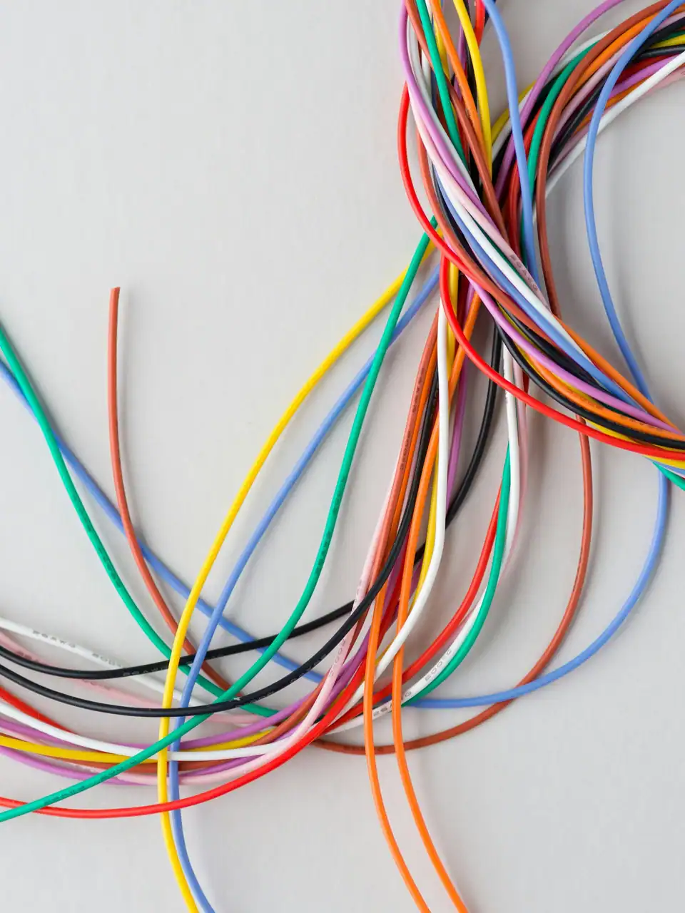 Colored lengths of wire fanned out on a white table