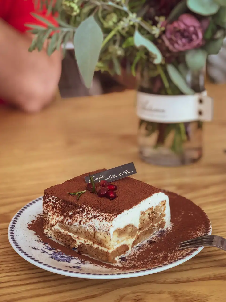 A slice of tiramisu dusted with cocoa