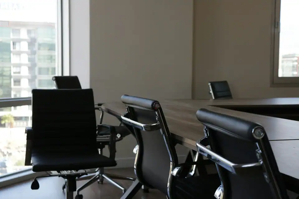 A meeting room with tall windows