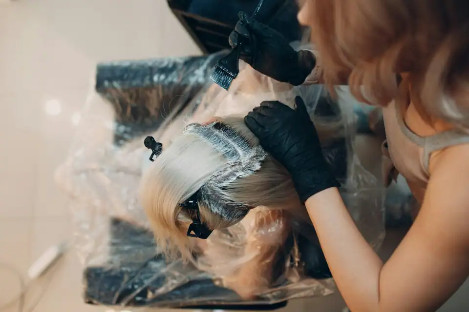 Color being painted onto lengths of hair