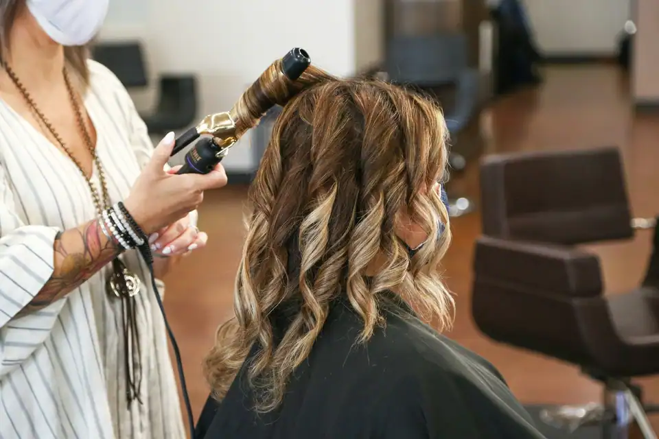 Soft curls being set with a curling iron