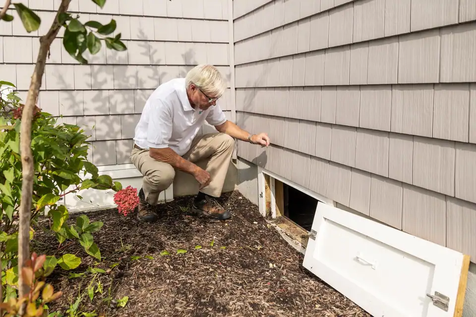 Mike Hartley inspecting outside a house