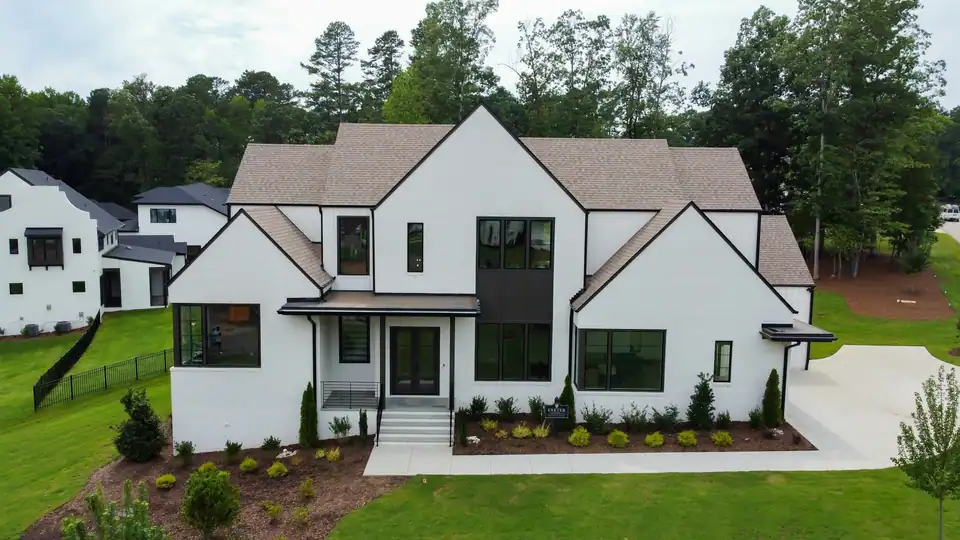 A new white farmhouse-style home with a dark roof